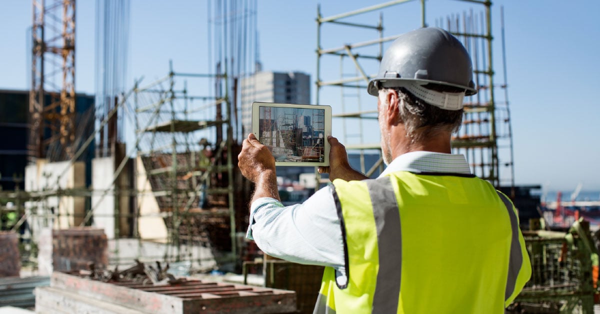 Contractor taking photo documentation on job site. 